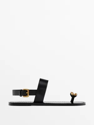 Flat sandals with metallic embellishment